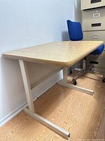 Front angled view showing full desk, laminate top, metal frame