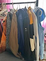Group shot of all seven outerwear pieces on rack