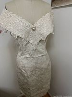 Front view on dress form showing full dress and off-shoulder neckline