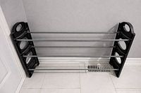 Overall view of the four-tier shoe rack showing construction and condition