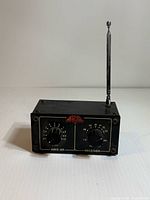Front view of Aria AWS-6R FM receiver with antenna and controls visible