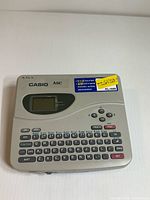 Top view of Casio KL-1500 label printer showing full keyboard and LCD