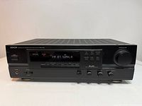 Front angled view of Denon receiver showing display, controls and overall condition