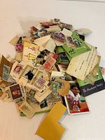 Pile of assorted stamps with trading card visible