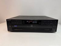 Front angled view of Sony CDP-C215 showing display, controls and disc tray