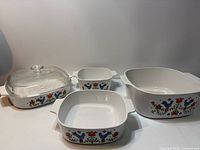 Four Corning Ware Festival Blue Birds casseroles with lid displayed