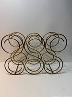 Front view of gold-tone circular metal wine rack