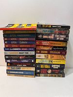 Two stacks of mass-market paperbacks showing spines and titles