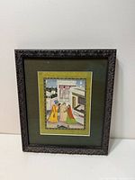Full view of framed miniature painting standing against wall