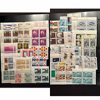 Two stock pages filled with Canadian mint plate blocks displayed front on