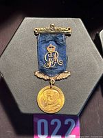 Front view of medal with ribbon and decorative fittings