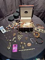 overview of entire jewellery lot on table showing box and contents