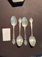 Front view of four Gorham Melrose sterling teaspoons