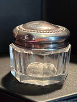 Full view of glass jar with sterling silver lid attached