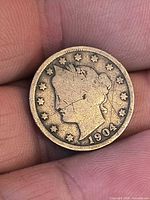 Obverse of 1904 Liberty Head nickel showing date and wear