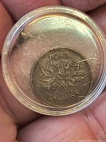 Reverse of 1941 Canada 1 cent coin showing maple leaves inside capsule