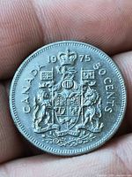 Reverse of 1975 Canadian 50-cent coin showing Coat of Arms and date