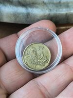 Reverse side of $2 coin in capsule showing aboriginal elder design