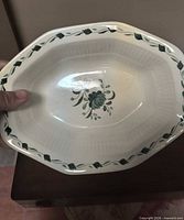 Top view of octagonal ceramic bowl showing floral center and vine border