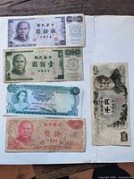 Front view of all five banknotes showing portraits, denominations and serial numbers