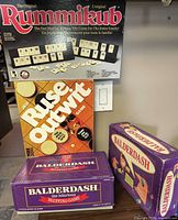 All four boxed board games stacked for overview
