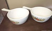 Both Corning Ware handled bowls side by side showing pattern and shape