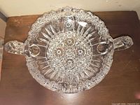 Top view of clear cut glass bowl showing pattern and both handles