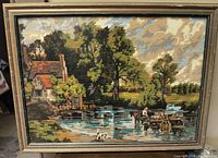 Front view of framed needlepoint landscape