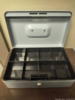 Box open showing plastic divided tray and key