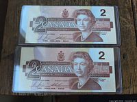 Fronts of both $2 Canadian banknotes showing Queen Elizabeth II portrait and denomination