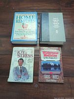 All four books front covers visible