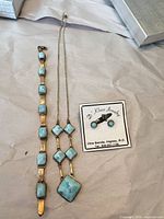 Full view of bracelet, necklace, earrings and brand card