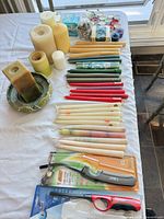 Overview of mixed candles, tapers, tealights, lighters, holder