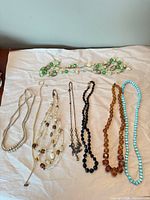 All seven necklaces laid out