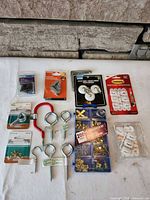 Overall view of all packaged and loose hardware items laid on surface