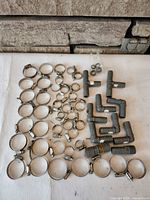 Full layout of clamps and PVC fittings on white surface