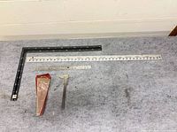 Lot overview with framing square, two rulers, vernier caliper in pouch