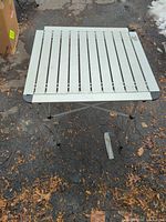 Top view of slatted aluminum tabletop with logo visible