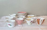 Group view of all teacups, saucers and plates on table