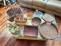 All eight baskets and trays displayed on glass table
