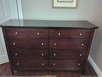 Front view showing eight drawers and metal knobs