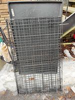 Crate folded flat with plastic tray behind