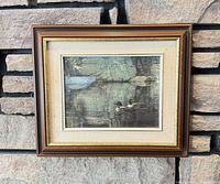 Framed print hung on stone wall showing full view and proportions