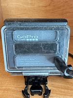 Rear view of GoPro HERO in housing showing branding and mount