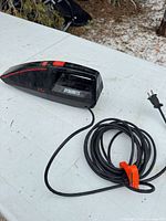 Left side view of Kenmore Dynamite handheld vacuum with coiled power cord