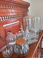 Group shot showing all large demijohns, jugs, jars, apothecary rack and smaller bottles