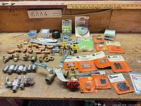 Workbench view of entire assortment of valves, fittings, washers, hoses, strapping and hardware