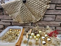 Full lot showing tree skirt, bin of ornaments, starburst ornaments, pinecones, ribbons, berry stems