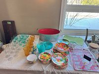 Overall layout showing plates, bowls, glassware, dispenser, tub