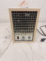 Front view showing grille, controls and power switch